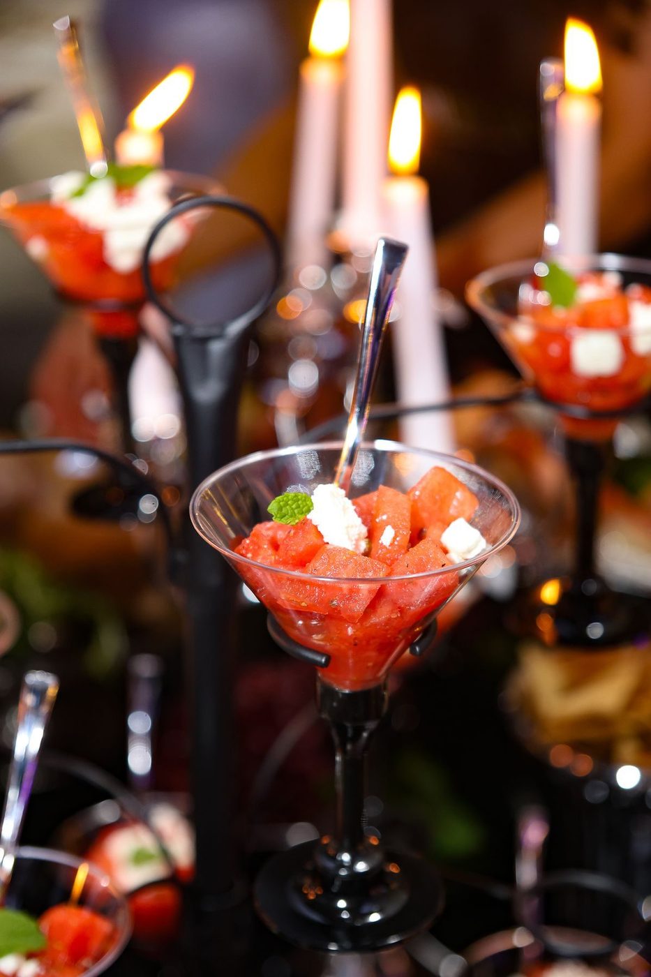 Seafood cocktails in coupe glasses by candlelight