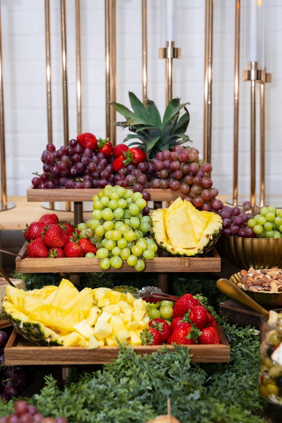 Tiered trays of grapes, strawberries and pineapple